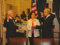 Senator Lugar swearing in Allen Weinstein as Archivist of the United States, with his wife Adrienne Weinstein holding the Bible.