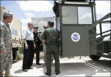 President George W. Bush speaks with members of the National Guard and U.S. Border Patrol officers during his tour along the U.S.-Mexico border Thursday, Aug. 3, 2006, in the Rio Grande Valley border patrol sector in Mission, Texas. White House photo by Eric Draper