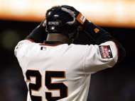 Barry Bonds adjusts his helmet after drawing a walk off the Nationals' John Lannan in the third inning of Monday's game in San Francisco.