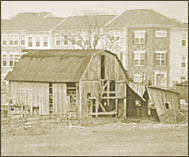 Photograph of old barn in front of new townhouse development.