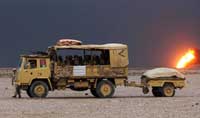 hoto of  a 4 Tonne truck towing a trailer in the desert