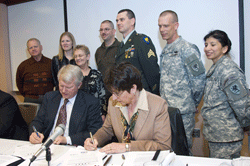 Mitch Irwin and Rebecca A. Humphries sign a statement of support for their employees in the Gaurd and reserve